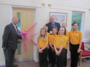 Cllr John Earl cuts the ribbon to open the IT suite