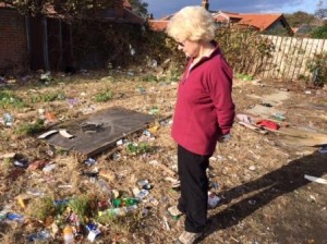 Cllr Irene Nightingale looks on appalled by the sea of litter in Henry Taylor Court, Ormesby